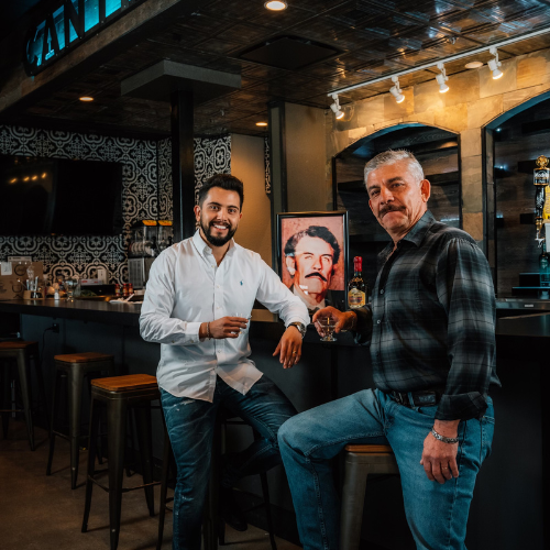 restaurant owner his father with a picture of his grandfather